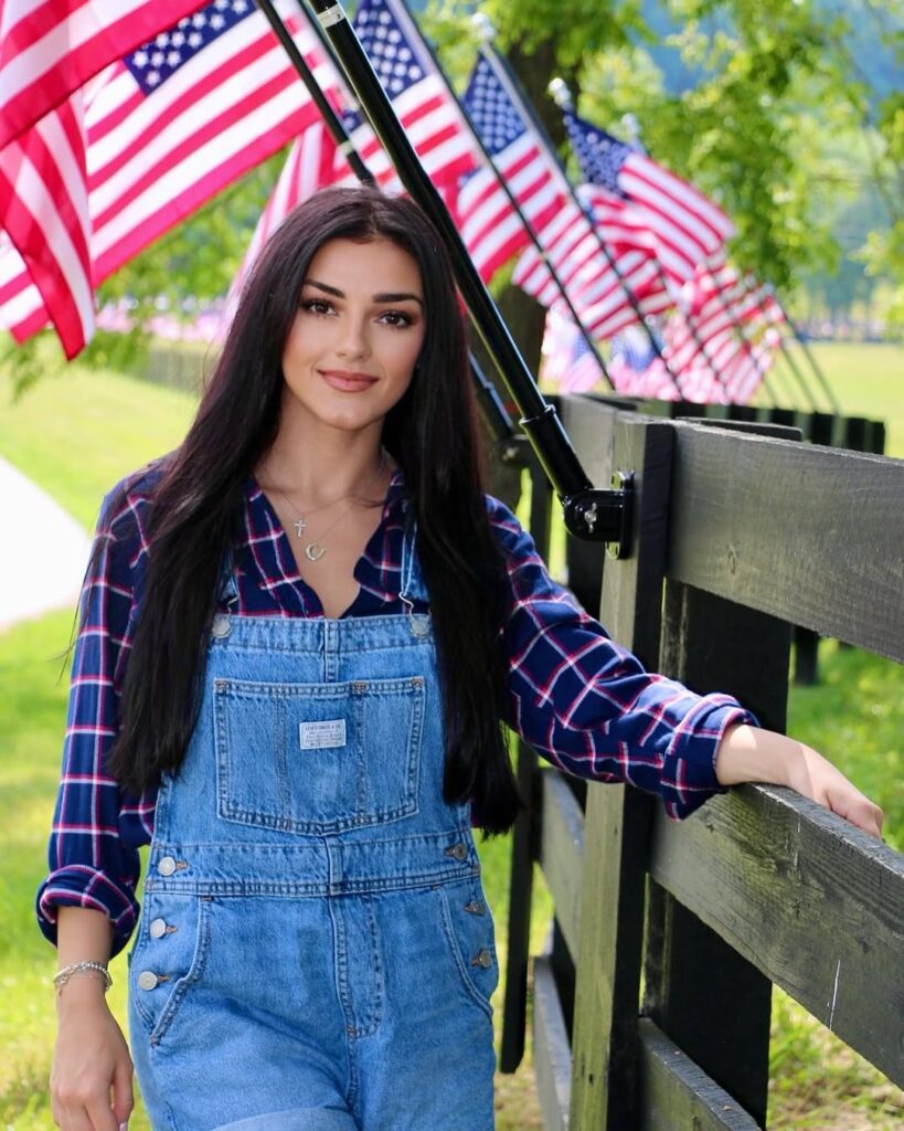 Alexis Wilkins with american flags in background