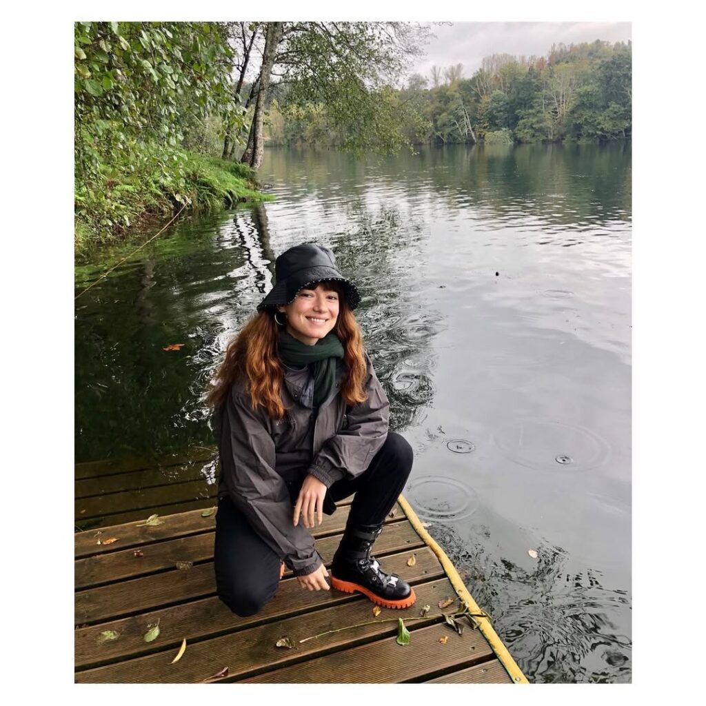 Andrea Tivadar enjoying the nature around a water body